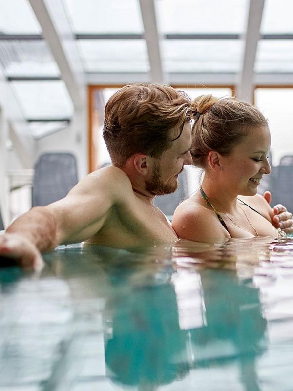 Relaxing together in the indoor swimming pool of the Hotel Hochschober 