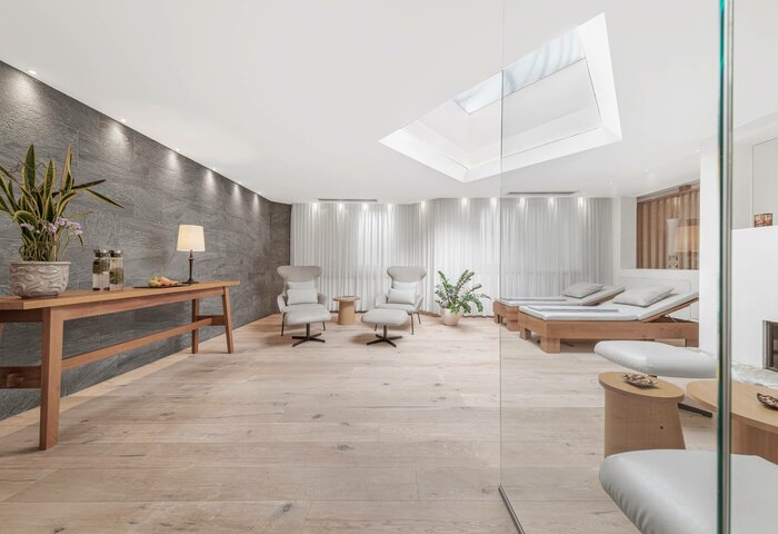 Ein heller Behandlungsraum mit zwei Sesseln, Liegen und einem Oberlicht im Kristall Spa des Hotel Hochschober.