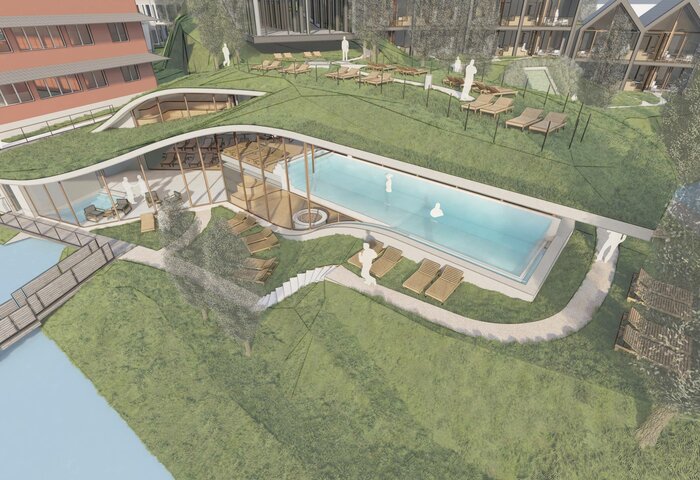 Ein Außenpool liegt auf einer begrünten Terrasse zwischen Gebäuden des Hotels Hochschober.