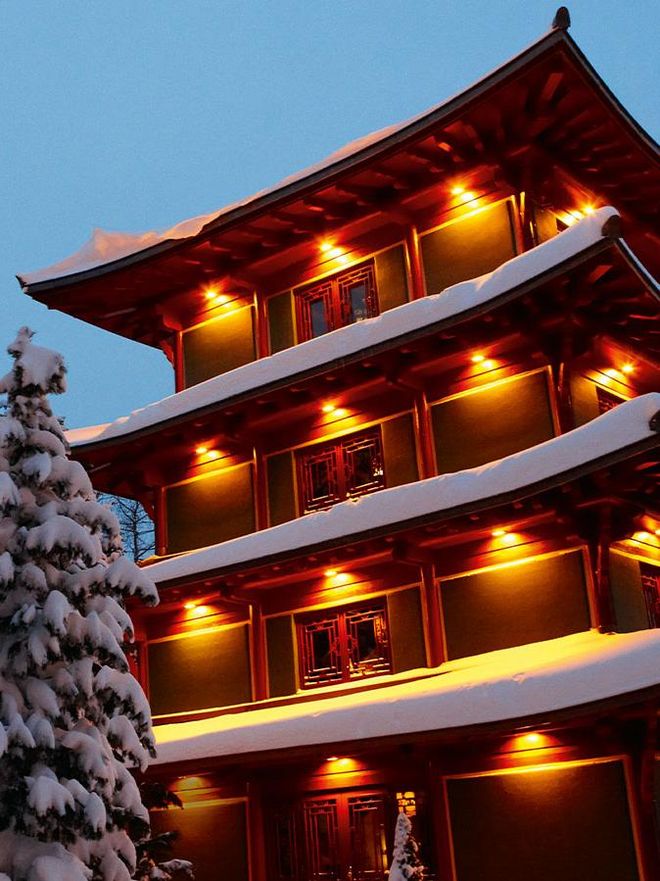 The illuminated Chinatower in winter from the outside in the Hotel Hochschober