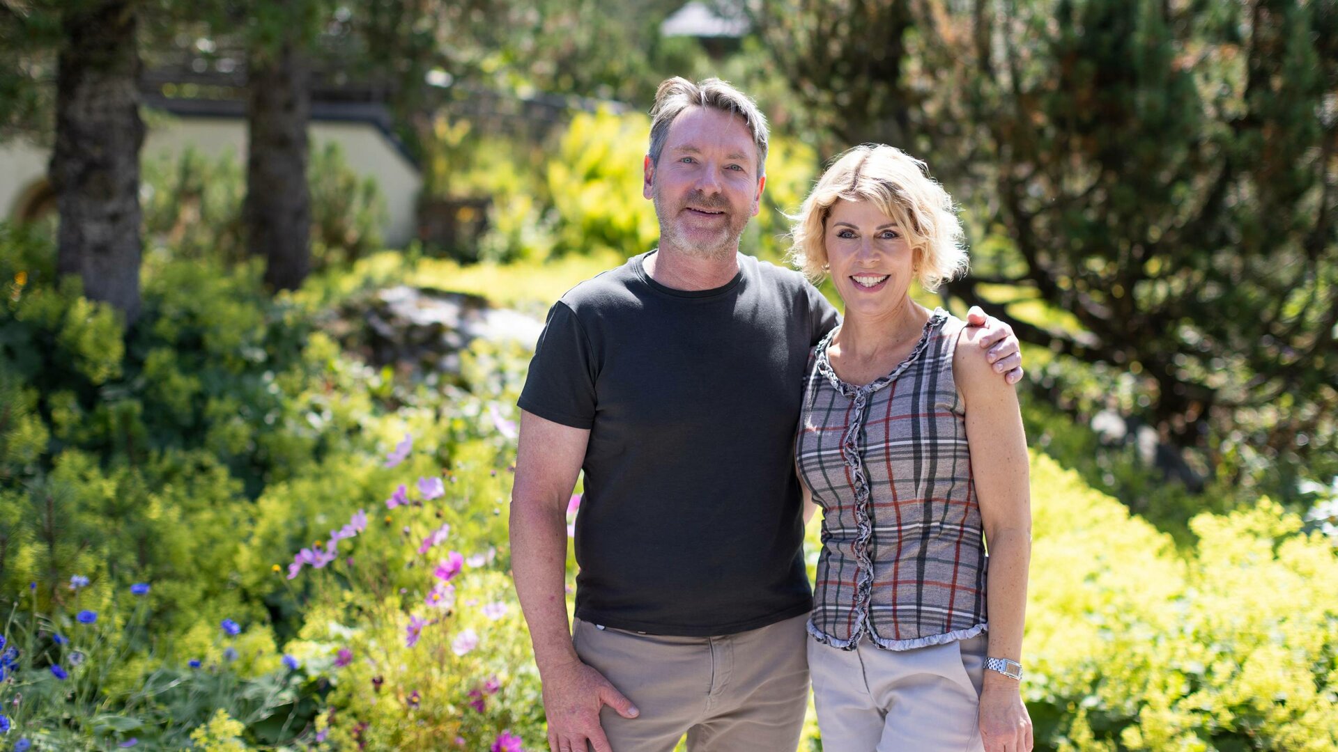 The Leeb and Klein host family stands smiling in a sunny garden at Hotel Hochschober.