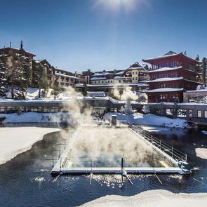 Sunny winter atmosphere at Hotel Hochschober with its heated lake pool