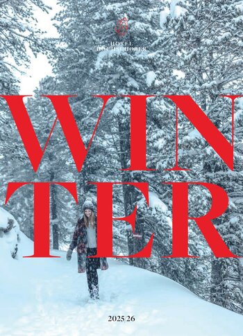 A person walks along a snowy forest path in winter, with the large text “WINTER 2025 26” over the image.