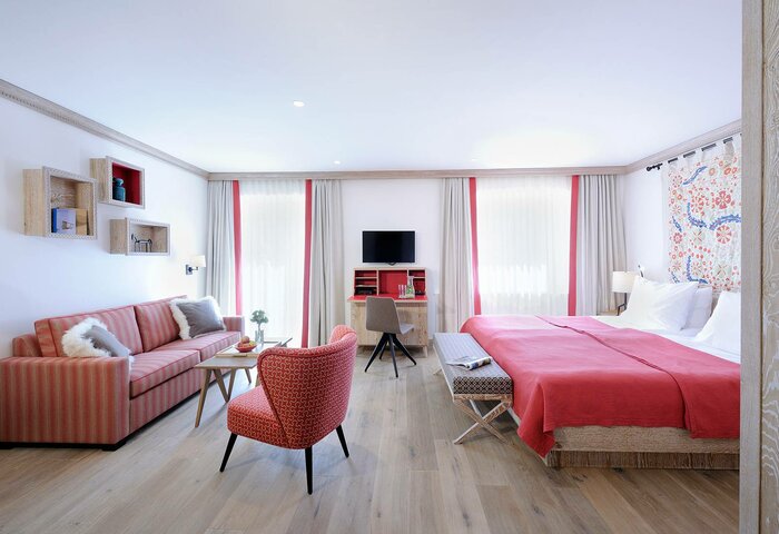 Superior double room in the main building The superior double room in the main building shows a bed, seating area and desk in a bright interior.